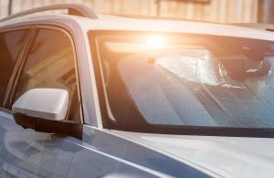 Car sitting in heat with sun reflecting off sun shade